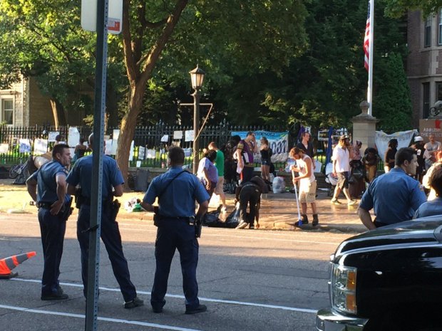 St. Paul police watch over the clearing of a protest encampment Monday, July 18, in front of the Governor's Residence in St. Paul. (Pioneer Press: Mary E. Divine)